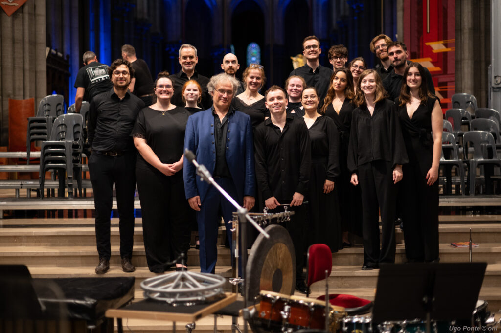 Le chœur Ineffable posant avec Thierry Escaich sur la scène après le concert, devant les percussions